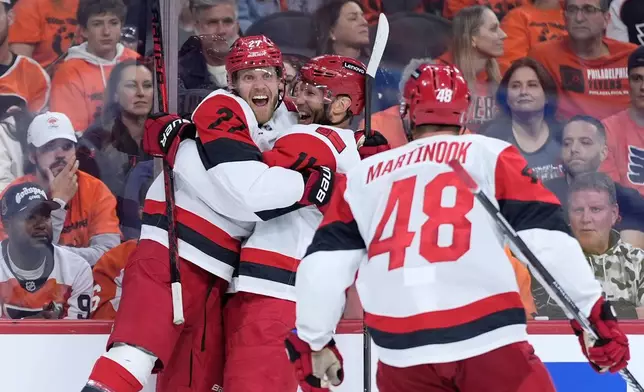Carolina Hurricanes' Nikolaj Ehlers, from left, Jordan Staal and Jordan Martinook celebrate after a goal by Ehlers during the third period of Game 3 in the second round of the NHL hockey Stanley Cup playoffs against the Philadelphia Flyers Thursday, May 7, 2026, in Philadelphia. (AP Photo/Matt Slocum)