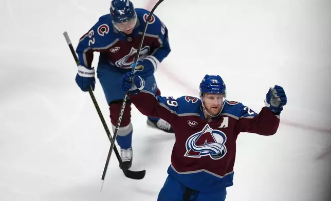 Colorado Avalanche center Nathan MacKinnon, front, and left wing Artturi Lehkonen react after center Martin Necas scored a goal against the Minnesota Wild in the first period of Game 2 of an NHL hockey Stanley Cup second-round playoff series Tuesday, May 5, 2026, in Denver. (AP Photo/David Zalubowski)