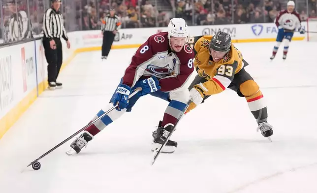 Vegas Golden Knights right wing Mitch Marner, right, reaches in on Colorado Avalanche defenseman Cale Makar during the first period in Game 3 of the Western Conference finals NHL hockey Stanley Cup playoff series Sunday, May 24, 2026, in Las Vegas. (AP Photo/Mark J. Terrill)