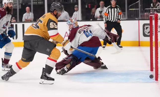 Vegas Golden Knights right wing Keegan Kolesar, left, gets set to score on Colorado Avalanche goaltender Scott Wedgewood during the second period in Game 3 of the Western Conference finals NHL hockey Stanley Cup playoff series Sunday, May 24, 2026, in Las Vegas. (AP Photo/Mark J. Terrill)