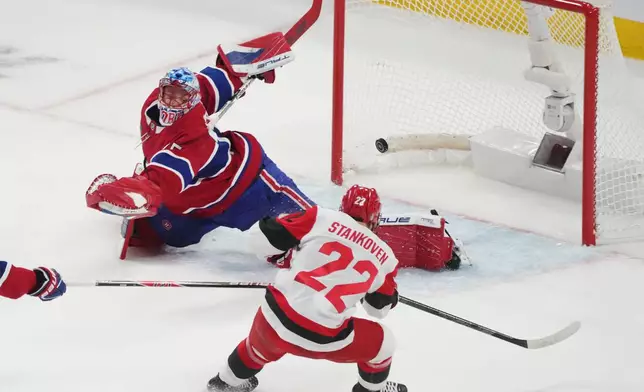 Carolina Hurricanes' Logan Stankoven (22) scores on Montreal Canadiens goaltender Jakub Dobes (75) during the first period of Game 4 of NHL Eastern Conference final Stanley Cup playoff series action in Montreal, Quebec, Wednesday, May 27, 2026. (Christinne Muschi/The Canadian Press via AP)