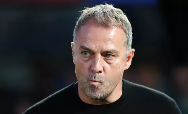 Barcelona head coach Hansi Flick stands by the touchline before the Spanish La Liga soccer match between FC Barcelona and Real Madrid in Barcelona, Spain, Sunday, May 10, 2026. (AP Photo/Joan Mateu Parra)