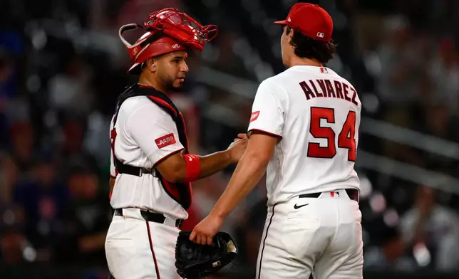 Washington Nationals' Keibert Ruiz, left, and Andrew Alvarez celebrate after a baseball game against the New York Mets, Wednesday, May 20, 2026, in Washington. (AP Photo/Nick Wass)