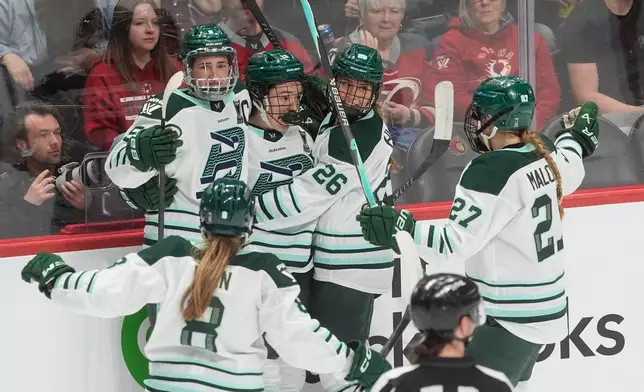 Boston Fleet's Liz Schepers, center rear, celebrates her goal against the Ottawa Charge with Haley Winn (8), Megan Keller, back left, Ella Huber (26) and Shay Maloney (27) during the second period of an PWHL hockey playoff game in Ottawa, Ontario, Friday, May 8, 2026. (Adrian Wyld/The Canadian Press via AP)