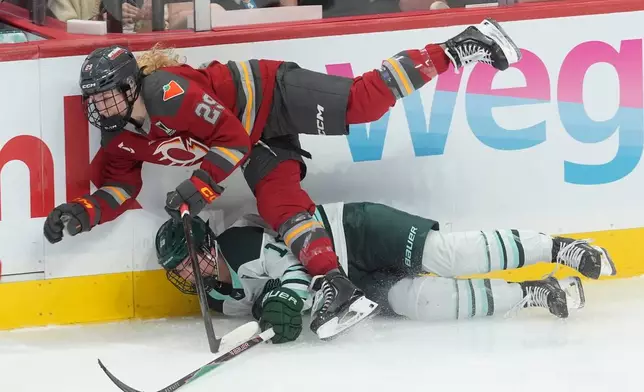 Ottawa Charge's Peyton Hemp (29) collides with Boston Fleet's Abby Newhook (19) during the third period of an PWHL hockey playoff game in Ottawa, Ontario, Friday, May 8, 2026. (Adrian Wyld/The Canadian Press via AP)