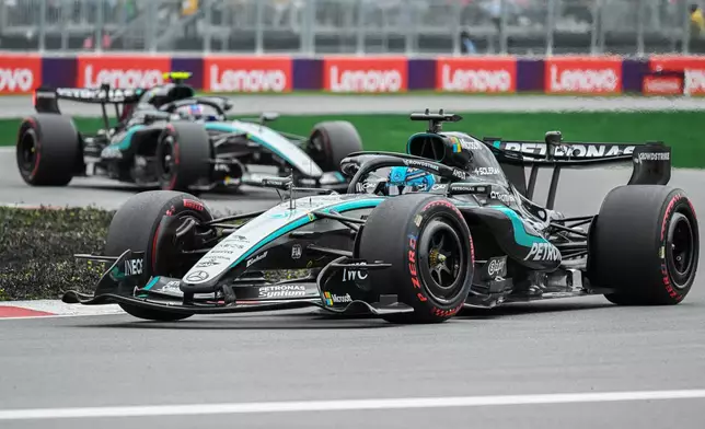 Mercedes driver George Russell, front, of Britain, takes a turn ahead of teammate Kimi Antonelli, of Italy, during the F1 Canadian Grand Prix auto race in Montreal, Sunday, May 24, 2026. (Graham Hughes/The Canadian Press via AP)