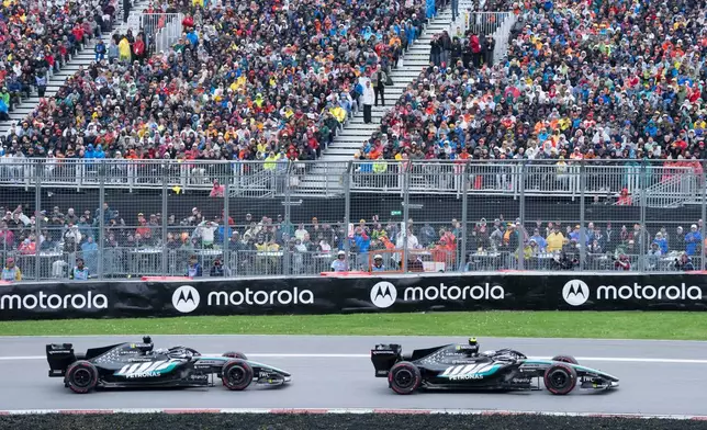 Mercedes driver Kimi Antonelli, right, of Italy, leads teammate Mercedes driver George Russell, of Britain, during the F1 Canadian Grand Prix auto race in Montreal, Sunday, May 24, 2026. (Christinne Muschi/The Canadian Press via AP)
