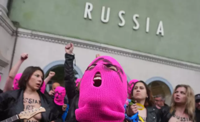 Pussy Riot and FEMEN activists stage a protest against Russia's presence after its absence following the 2022 invasion of Ukraine in front of the Russian pavilion, at the 2026 Art Venice Biennale, in Venice, Italy, Wednesday, May 6, 2026. (AP Photo/Luca Bruno)