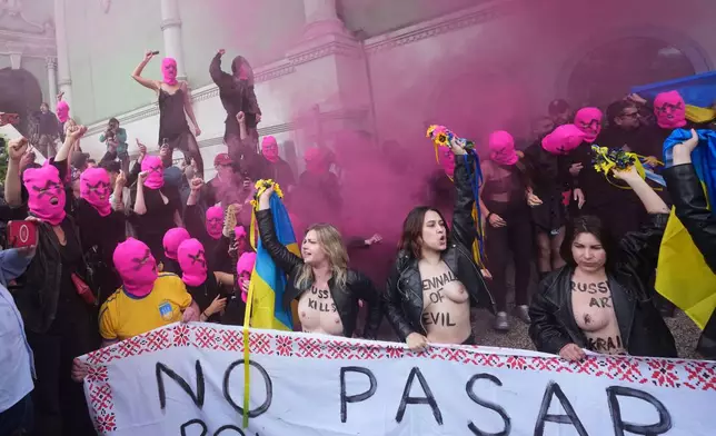 EDS NOTE: NUDITY - Pussy Riot and FEMEN activists stage a protest against Russia's presence after its absence following its 2022 invasion of Ukraine in front of the Russian pavilion, at the 2026 Art Venice Biennale, in Venice, Italy, Wednesday, May 6, 2026. (AP Photo/Luca Bruno)