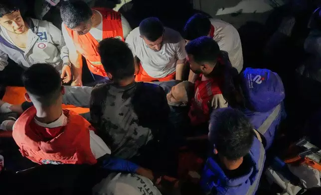 Rescue workers carry an injured man from a destroyed apartment that was hit in an Israeli airstrike in the southern port city of Sidon, Lebanon, Thursday, May 28, 2026. (AP Photo/Mohammed Zaatari)