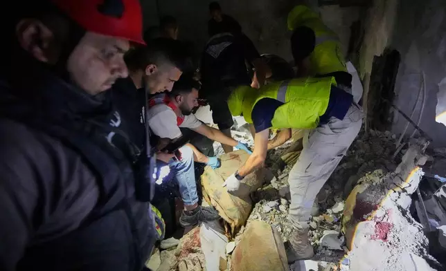 Rescue workers search for victims inside a destroyed apartment that was hit in an Israeli airstrike in the southern port city of Sidon, Lebanon, Thursday, May 28, 2026. (AP Photo/Mohammed Zaatari)