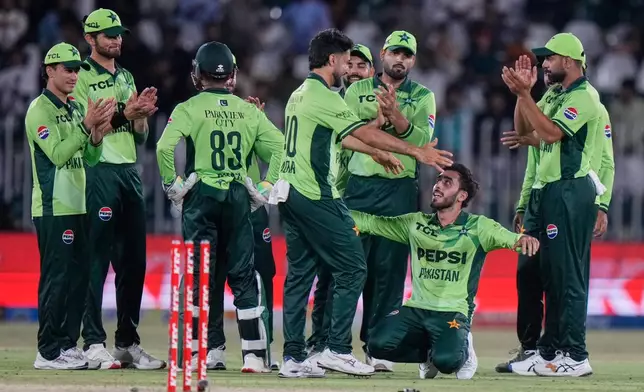 Pakistan's Arafat Minhas, bottom second right, celebrates with teammates after taking wicket of Australia's Nathan Ellis during the first One Day International cricket match between Pakistan and Australia, in Rawalpindi, Pakistan, Saturday, May 30, 2026. (AP Photo/Anjum Naveed)