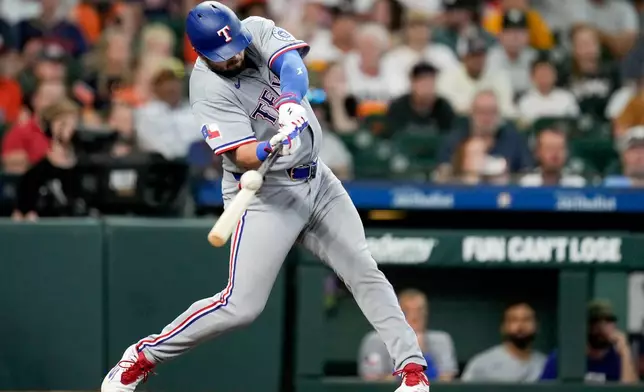 Texas Rangers' Jake Burger hits a two-run home run against the Houston Astros during the fifth inning of a baseball game, Sunday, May 17, 2026, in Houston. (AP Photo/Eric Christian Smith)