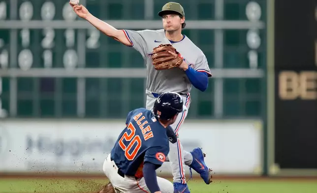 Texas Rangers second baseman Justin Foscue, top, completes a double play over Houston Astros' Nick Allen (20) during the third inning of a baseball game, Sunday, May 17, 2026, in Houston. (AP Photo/Eric Christian Smith)