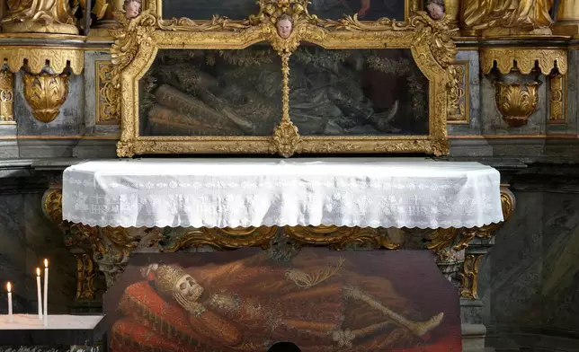 An elaborately decorated skeleton lies in the catholic monastery church of Banz in Bad Staffelstein, Germany, Saturday, May 2, 2026. (AP Photo/Matthias Schrader)