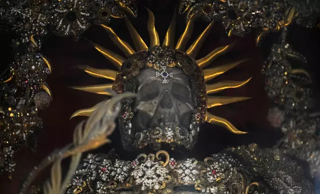 An elaborately decorated skeleton stands in the catholic monastery church of Banz in Bad Staffelstein, Germany, Saturday, May 2, 2026. (AP Photo/Matthias Schrader)