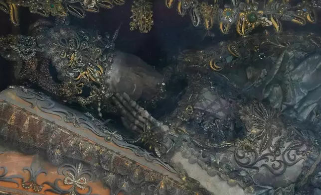 An elaborately decorated skeleton lies in the catholic monastery church of Banz in Bad Staffelstein, Germany, Saturday, May 2, 2026. (AP Photo/Matthias Schrader)