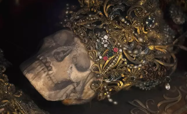 An elaborately decorated skeleton lies in the catholic monastery church of Banz in Bad Staffelstein, Germany, Saturday, May 2, 2026. (AP Photo/Matthias Schrader)