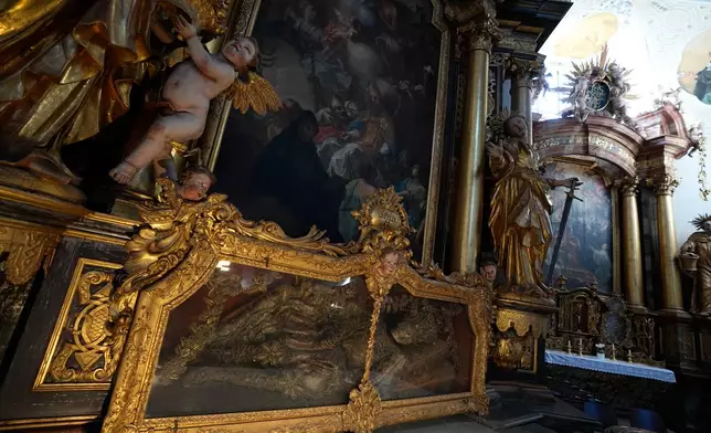 An elaborately decorated skeleton lies in the catholic monastery church of Banz in Bad Staffelstein, Germany, Saturday, May 2, 2026. (AP Photo/Matthias Schrader)