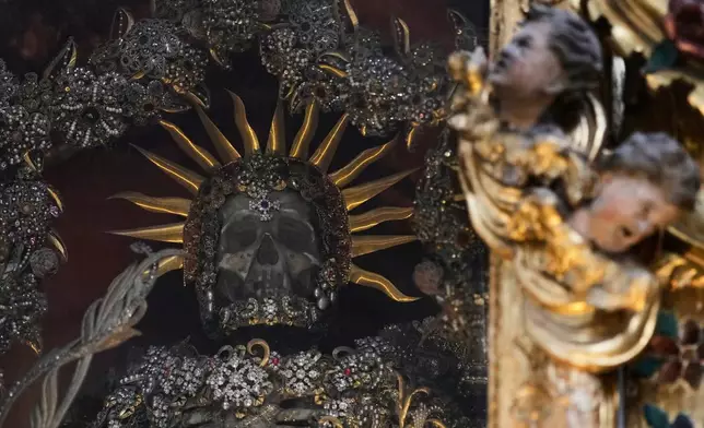 An elaborately decorated skeleton lies in the catholic monastery church of Banz in Bad Staffelstein, Germany, Saturday, May 2, 2026. (AP Photo/Matthias Schrader)