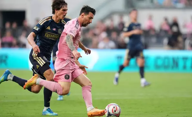 Inter Miami forward Lionel Messi (10) drives downfield under pressure from Philadelphia Union midfielder Ben Bender (16) during the first half of an MLS soccer match, Sunday, May 24, 2026, in Miami. (AP Photo/Rebecca Blackwell)