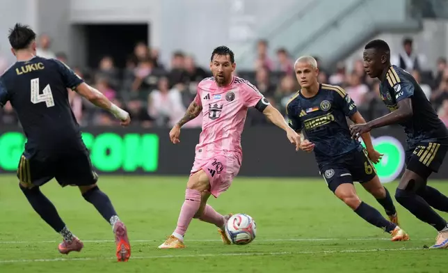 Inter Miami forward Lionel Messi (10) comes under pressure from Philadelphia Union midfielder Jovan Lukic (4), midfielder Cavan Sullivan (6), and midfielder Danley Jean Jacques (21), during the first half of an MLS soccer match, Sunday, May 24, 2026, in Miami. (AP Photo/Rebecca Blackwell)