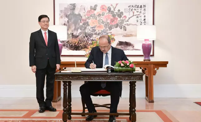 The Chief Executive, Mr John Lee (left), met with the visiting Prime Minister of Uzbekistan, Mr Abdulla Nigmatovich Aripov (right), at Government House today (May 6). Photo shows Mr Aripov signing the guest book at Government House. Source: HKSAR Government Press Releases