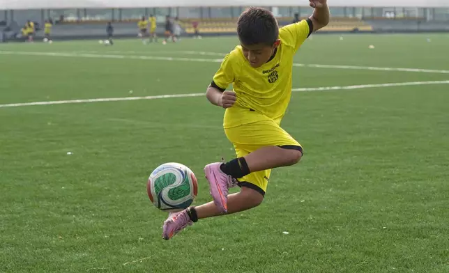 A boy controls the ball during practice at a Barcelona FC-sponsored soccer academy in Guayaquil, Ecuador, Thursday, May 14, 2026. (AP Photo/Dolores Ochoa)