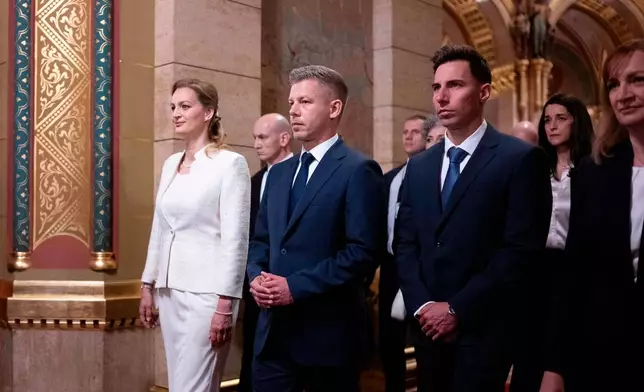 Hungarian Prime Minister-elect Peter Magyar, center, arrives with fellow lawmakers at the Parliament building in Budapest, Hungary, Saturday, May 9, 2026. (AP Photo/Denes Erdos)