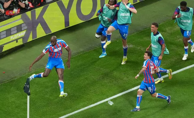 Crystal Palace's Jean-Philippe Mateta, left, celebrates with teammates after scoring his side's opening goal during the Europa Conference League final soccer match between Crystal Palace and Rayo Vallecano in Leipzig, Germany, Wednesday, May 27, 2026. (AP Photo/Markus Schreiber)