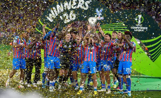 Crystal Palace players with the trophy of the Europa Conference League after the final soccer match between Crystal Palace and Rayo Vallecano in Leipzig, Germany, Wednesday, May 27, 2026. (AP Photo/Michael Probst)