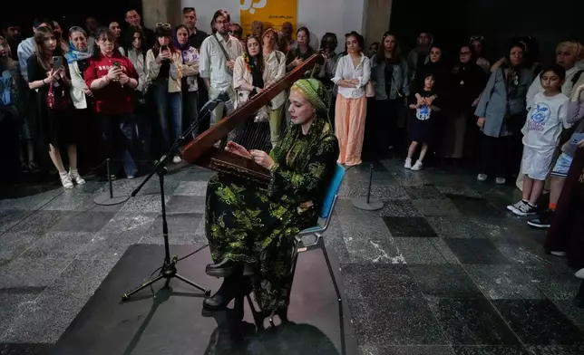Musician Saleheh Zohrehvand plays the harp during a performance dubbed "Sounds of the South," featuring music from southern Iran, at the Tehran Museum of Contemporary Art in Tehran, Iran, Thursday, May 21, 2026. (AP Photo/Vahid Salemi)