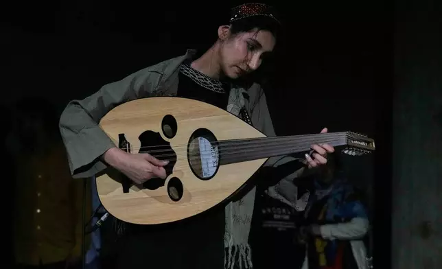 Musician Atena Kharyaband plays the oud during a performance dubbed "Sounds of the South," featuring music from southern Iran, at the Tehran Museum of Contemporary Art in Tehran, Iran, Thursday, May 21, 2026. (AP Photo/Vahid Salemi)