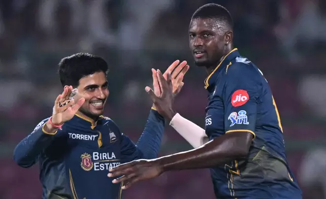 Gujarat Titans' Jason Holder, right, celebrates with Shubman Gill the wicket of Rajasthan Royals' Jofra Archer during the Indian Premier League cricket match between Rajasthan Royals and Gujarat Titans in Jaipur, India, Saturday, May 9, 2026. (AP Photo/ Str)