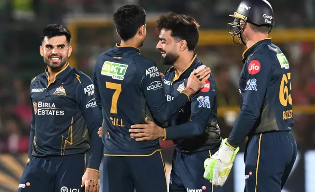 Gujarat Titans' Rashid Khan, centre, celebrates with teammates the wicket of Rajasthan Royals' Dhruv Jurel during the Indian Premier League cricket match between Rajasthan Royals and Gujarat Titans in Jaipur, India, Saturday, May 9, 2026. (AP Photo/ Str)