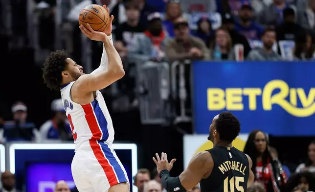 Detroit Pistons guard Cade Cunningham takes a shot against Cleveland Cavaliers guard Donovan Mitchell (45) during the first half in Game 2 of a second-round NBA playoffs basketball series, Thursday, May 7, 2026, in Detroit. (AP Photo/Duane Burleson)