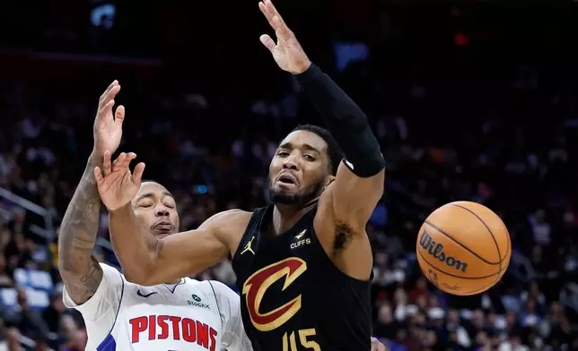 Cleveland Cavaliers guard Donovan Mitchell (45) looses the ball against the defense from Detroit Pistons forward Ronald Holland II during the first half in Game 2 of a second-round NBA playoffs basketball series, Thursday, May 7, 2026, in Detroit. (AP Photo/Duane Burleson)