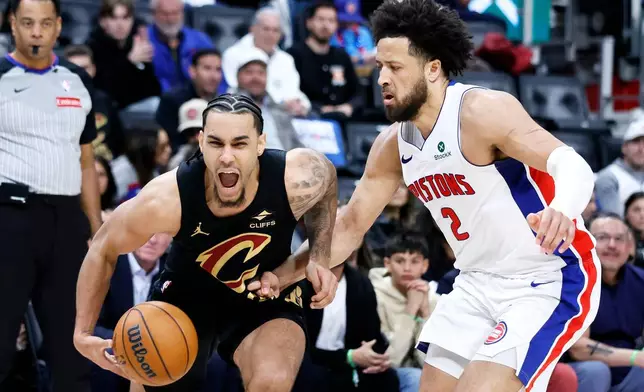 Cleveland Cavaliers guard Jaylon Tyson, left, drives against Detroit Pistons guard Cade Cunningham (2) during the first half in Game 2 of a second-round NBA playoffs basketball series, Thursday, May 7, 2026, in Detroit. (AP Photo/Duane Burleson)
