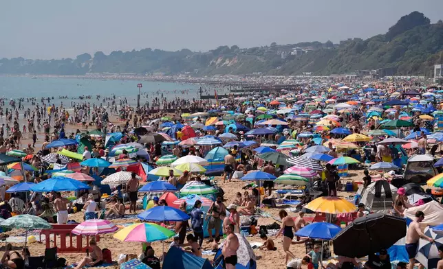 People visit Bournemouth beach, south England, Monday May 25, 2026. (Andrew Matthews/PA via AP)