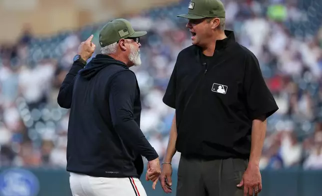 Minnesota Twins manager Derek Shelton, left, argues with umpire Jordan Baker after being ejected during the eighth inning of a baseball game against the Milwaukee Brewers, Friday, May 15, 2026, in Minneapolis. (AP Photo/Matt Krohn)