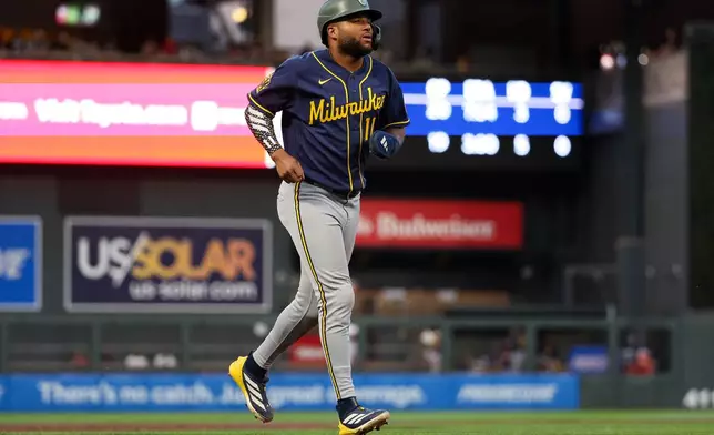 Milwaukee Brewers' Jackson Chourio scores on an interference call by Minnesota Twins third baseman Royce Lewis during the eighth inning of a baseball game, Friday, May 15, 2026, in Minneapolis. (AP Photo/Matt Krohn)