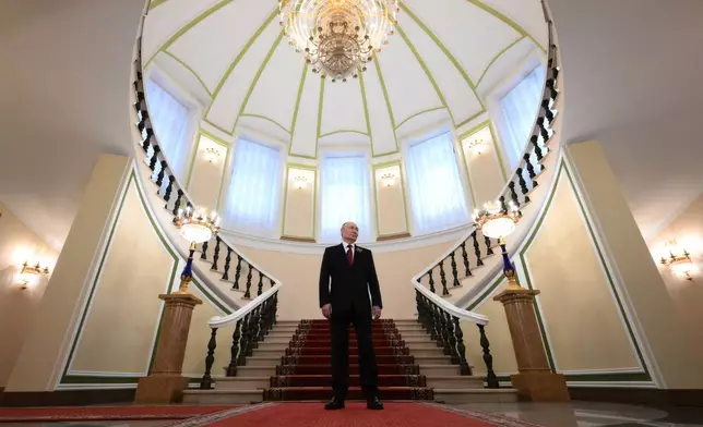 Russian President Vladimir Putin waits to greet heads of foreign delegations attend a reception marking the 81st anniversary of the victory over Nazi Germany in WWII, at the Kremlin in Moscow, Saturday, May 9, 2026. (Grigory Sysoev, Sputnik, Kremlin Pool Photo via AP)