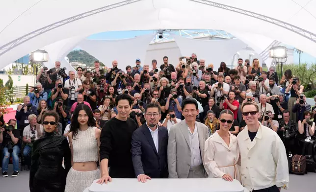 Taylor Russell, from left, Hoyeon, Zo In-sung, director Na Hong-jin, Hwang Jung-min, Alicia Vikander and Michael Fassbender pose for photographers at the photo call for the film 'Hope' during the 79th international film festival, Cannes, southern France, Monday, May 18, 2026. (AP Photo/John Locher)