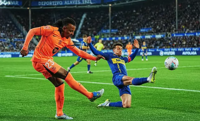 Barcelona's Jules Kounde, left, and Alaves' Antonio Blanco challenge for the ball during the Spanish La Liga soccer match between Alaves and Barcelona in Vitoria-Gasteiz, Spain, Wednesday, May 13, 2026. (AP Photo/Miguel Oses)