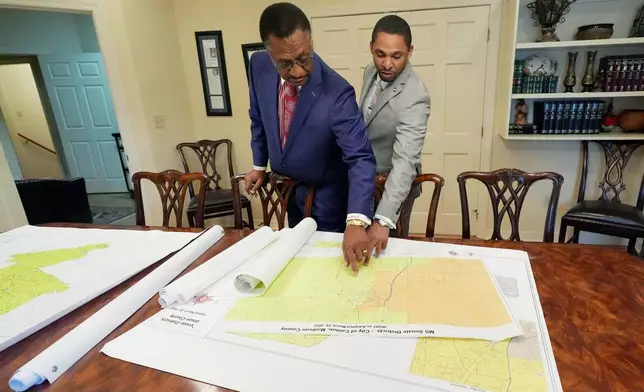 Attorney Edward Blackmon Jr., 78, a civil rights attorney and a former state representative, left, and his son, State Sen. Bradford Blackmon, D-Canton, review a 2022 redistricting map in their law office in Canton, Miss., Friday, May 1, 2026. (AP Photo/Rogelio V. Solis)
