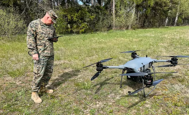 A U.S marine serviceman stands next to a TRV 150 drone during a military exercises in Gotland, Sweden, Monday, May 11, 2026. (AP Photo/Emma Burrows)