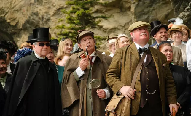 From left: Peter Horrocks, as Professor Moriarty, Philip Porter as Sherlock Holmes. and Charles Miller, as Doctor Watson, during an event recreating the fateful confrontation between Sherlock Holmes and Professor Moriarty by the members of the Sherlock Holmes Society of London, at the Reichenbach Falls, Switzerland, May 3, 2026. (AP Photo/Niccolo Lupone, Pool)