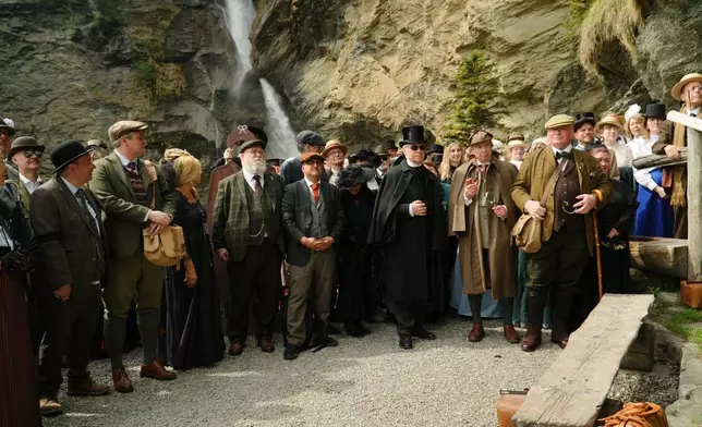 Members of the Sherlock Holmes Society of London recreate the fateful confrontation between Sherlock Holmes and Professor Moriarty at the Reichenbach Falls, Switzerland, May 3, 2026. (AP Photo/Niccolo Lupone, Pool)
