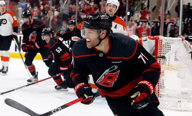 Carolina Hurricanes' Taylor Hall (71) celebrates after his winning overtime goal against the Philadelphia Flyers during Game 2 of an NHL hockey Stanley Cup second-round playoff series in Raleigh, N.C., Monday, May 4, 2026. (AP Photo/Karl DeBlaker)