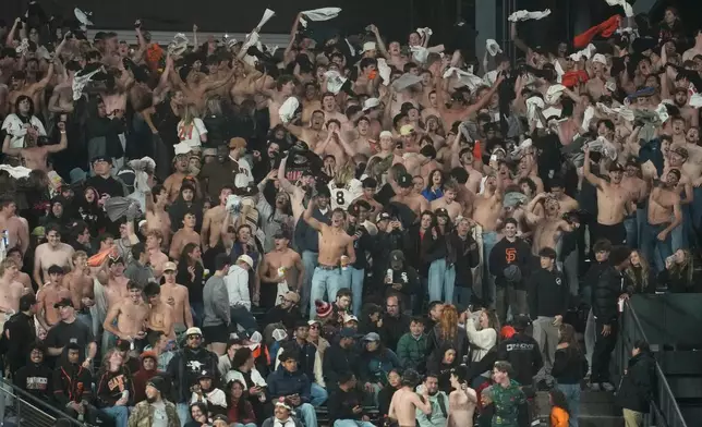 Fans at Oracle Park go "tarps off" during the eighth inning of a baseball game between the San Francisco Giants and the Chicago White Sox Friday, May 22, 2026, in San Francisco. (AP Photo/Jeff Chiu)